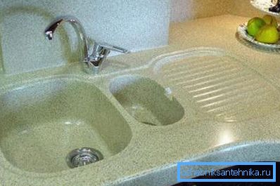 Auf dem Foto - ein Waschbecken unter dem Stein in der Küche mit zwei Schüsseln und Platz für Geschirr